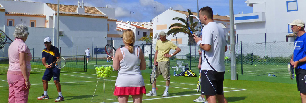 Small tennis group with tennis coach