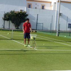 Children playing tennis in the sun