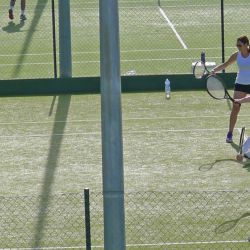 Small tennis group enjoys backhand drill