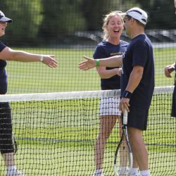 Adult tennis players shake hands