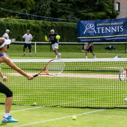 Adult tennis players at the net 