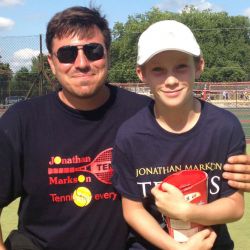 Tennis player receiving prize from Head Tennis Coach