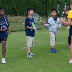 Young tennis players receiving coaching, Oxford 