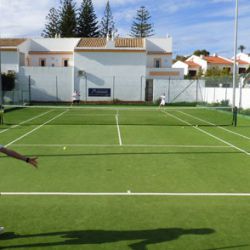Family plays tennis on the Luz Bay Hotel courts
